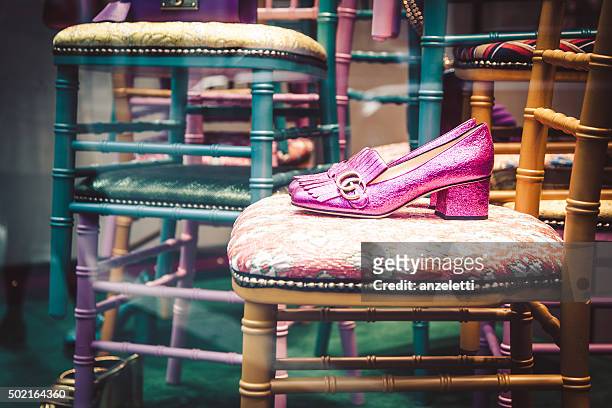 gucci shop window in via napoleone - gucci shoe stock pictures, royalty-free photos & images