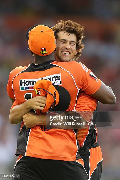 Ashton Agar of the Scorchers celebrates after taking a catch to dismiss Brad Hodge of the Strikers during the Big Bash League match between Perth...