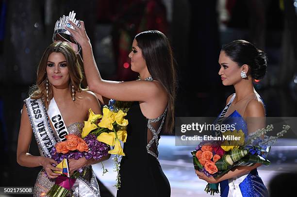 Miss Colombia 2015, Ariadna Gutierrez Arevalo, looks on as Miss Universe 2014 Paulina Vega removes her crown to give it to Miss Phillipines 2015, Pia...