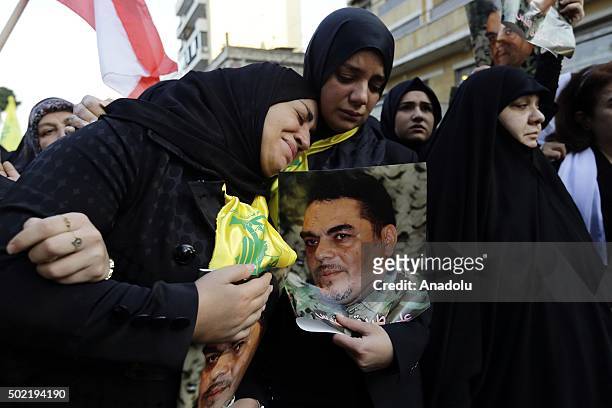People mourn during a funeral ceremony held for Samir Kuntar, a Hezbollah military commander killed on Sunday by an airstrike -- for which the group...