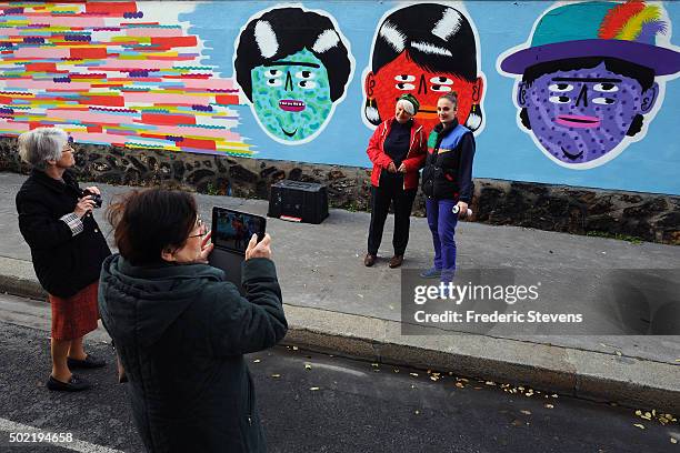 The artist Kashink poses in front of his work with her mother at the Rosa Parks Wall which consists of a huge street art mural 450 meters long made...