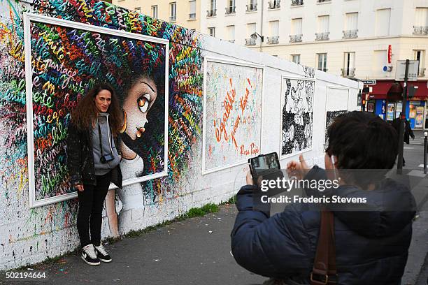 The artist poses in front of his work at the Rosa Parks Wall which consists of a huge street art mural 450 meters long made by iconic street-artist...