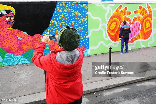Person stops and looks at the Rosa Parks Wall which consists of a huge street art mural 450 meters long made by iconic street-artist team composed of...