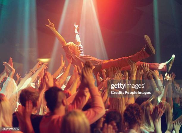 lift me higher! - crowdsurfing stock pictures, royalty-free photos & images