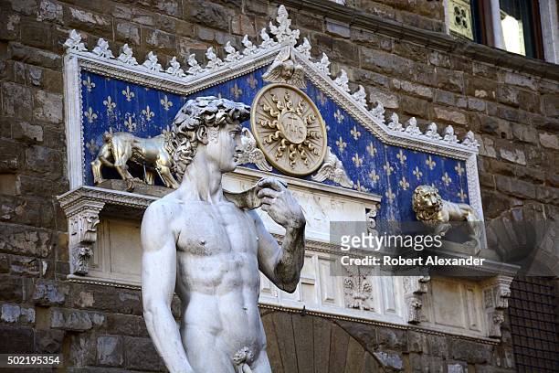 Full-size copy of Michelangelo's marble statue of the Biblical hero David stands in the Piazza della Signoria beside the Palazzo Vecchio in Florence,...