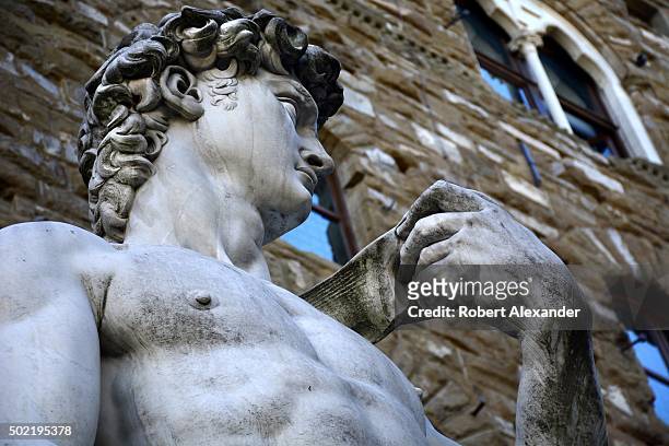 Full-size copy of Michelangelo's marble statue of the Biblical hero David stands in the Piazza della Signoria beside the Palazzo Vecchio in Florence,...