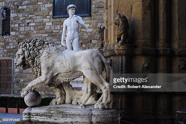 Full-size replica of Michelangelo's marble statue of the Biblical hero David is seen behind one of a pair of 16th century marble lions on display in...