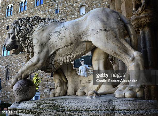 Full-size replica of Michelangelo's marble statue of the Biblical hero David is seen through one of a pair of 16th century marble lions on display in...