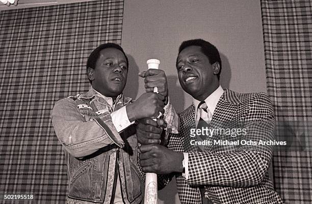 Flip Wilson and Hank Aaron have fun with a bat during a press conference before filming NBC-TV's "The Flip Wilson Show" on October 15, 1973 in...