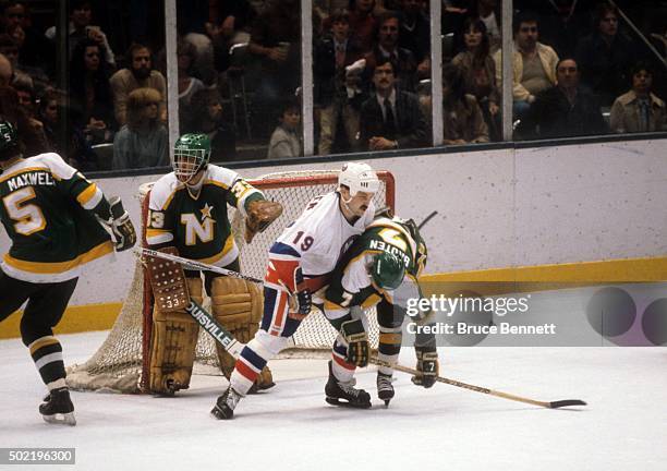 Neal Broten of the Minnesota North Stars is checked by Bryan Trottier of the New York Islanders during the 1981 Stanley Cup Finals in May, 1981 at...