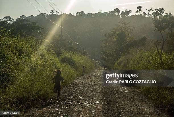 Waorani indigenous children run in Gareno, 175 km southeast of Quito, Ecuador on December 7, 2015. Three Amazonian ethnic groups of Ecuador, Brazil...