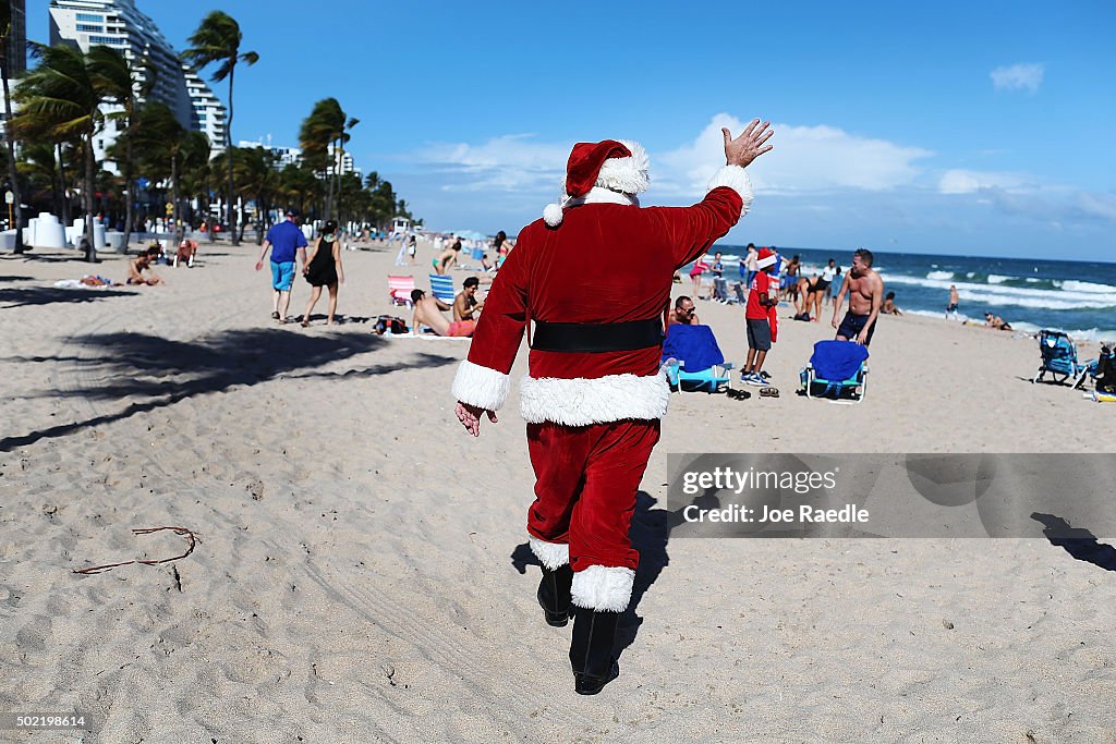 Santa Passes Out Presents On The Beach In Fort Lauderdale, Florida