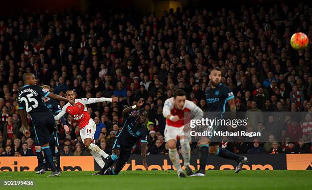 Theo Walcott of Arsenal scores his side's opening goal during the Barclays Premier League match between Arsenal and Manchester City at Emirates...