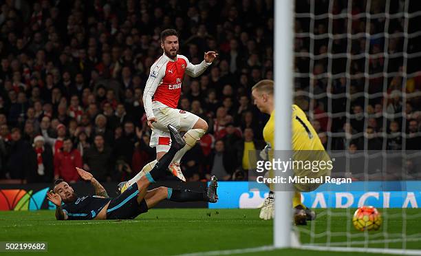 Olivier Giroud of Arsenal scores his side's second goal past Joe Hart of Manchester City during the Barclays Premier League match between Arsenal and...