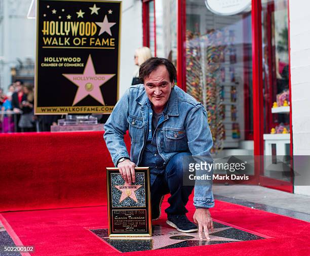 Filmmaker and Director Quentin Tarantino poses with his star on the Hollywood Walk of Fame on December 21, 2015 in Hollywood, California.