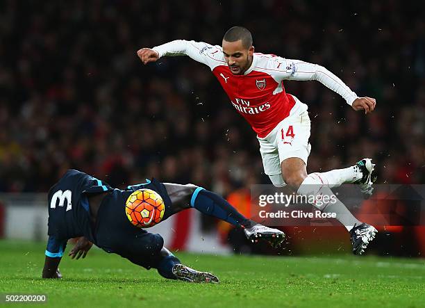 Theo Walcott of Arsenal skips a challenge by Bacary Sagna of Manchester City during the Barclays Premier League match between Arsenal and Manchester...