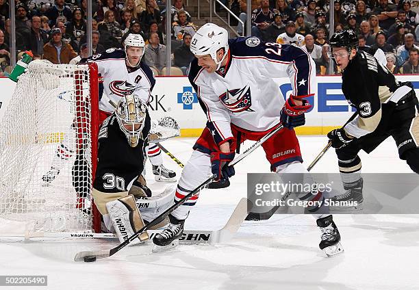 David Clarkson of the Columbus Blue Jackets controls the puck in front of Matt Murray and Olli Maatta of the Pittsburgh Penguins at Consol Energy...
