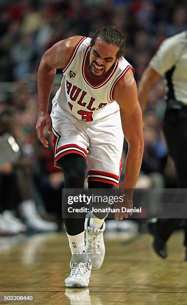 Joakim Noah of the Chicago Bulls is in pain after suffering an injury in the 3rd quarter against the Brooklyn Nets at the United Center on December...