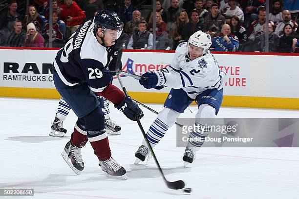 Matt Hunwick of the Toronto Maple Leafs draws a penalty for slashing against Nathan MacKinnon of the Colorado Avalanche at Pepsi Center on December...