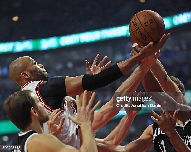 Taj Gibson of the Chicago Bulls puts up a shot against the Brooklyn Nets at the United Center on December 21, 2015 in Chicago, Illinois. The Nets...