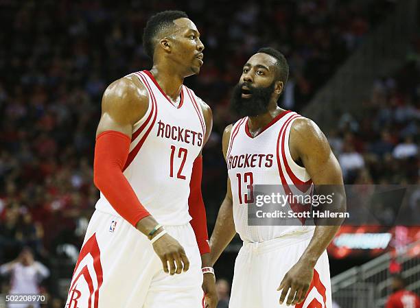 Dwight Howard and James Harden of the Houston Rockets walk across the court during their game against the Charlotte Hornets at Toyota Center on...