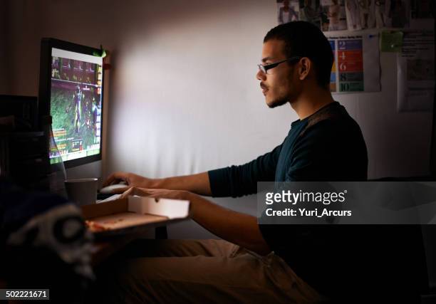 engrossed in his online world - gaming world championship stock pictures, royalty-free photos & images