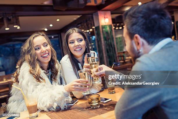 group of friends celebrating at restaurant and toasting with vodka - vodka stock pictures, royalty-free photos & images