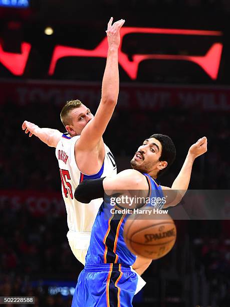 Cole Aldrich of the Los Angeles Clippers and Enes Kanter of the Oklahoma City Thunder collide for a loose ball during the first half at Staples...