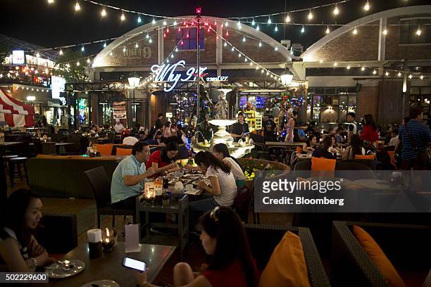 People dine at a restaurant at Asiatique The Riverfront open-air mall in Bangkok, Thailand, on Friday, Dec. 18, 2015. Thai economic indicators have...