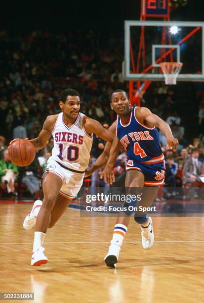 Maurice Cheeks of the Philadelphia 76ers drives on Darryl Walker of the New York Knicks during an NBA basketball game circa 1983 at The Spectrum in...