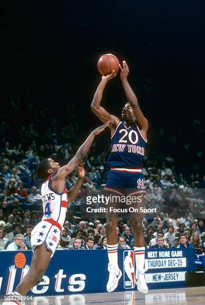 Michael Ray Richardson of the New York Knicks shoots over Wes Matthews of the Washington Bullets during an NBA basketball game circa 1980 at the...