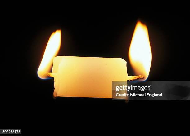 burning the candle at both ends - burning the candle at both ends stock pictures, royalty-free photos & images