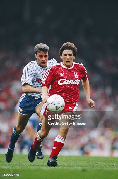 Liverpool striker Peter Beardsley outpaces Manchester United defender Mal Donaghy on his way to scoring his third and Liverpool's fourth goal during...
