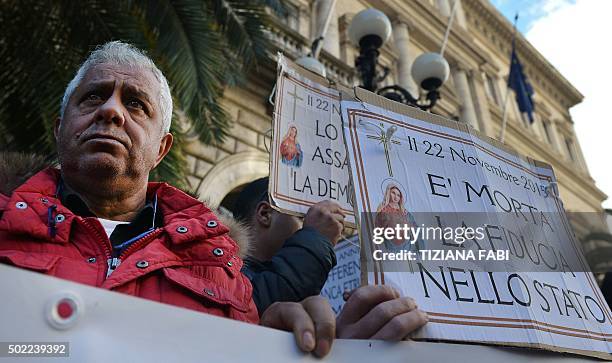 People take part in a protest against the collapse of four Italian banks in central Rome on December 22, 2015. The four regional Italian banks --...