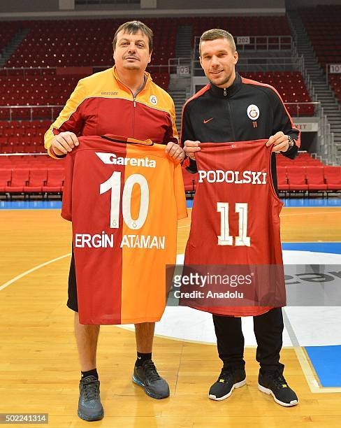 Galatasaray striker Lukas Podolski and Galatasaray Odeabank head coach Ergin Ataman pose as Podolski visits the Galatasaray Odeabank Men's Basketball...