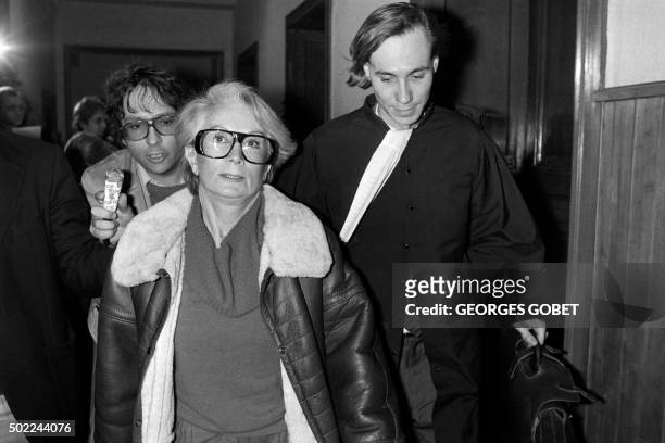File picture taken on January 20, 1986 shows Fernande Grudet also known as Madame Claude walking with her lawyer Bruno Simonetta at the Court of...