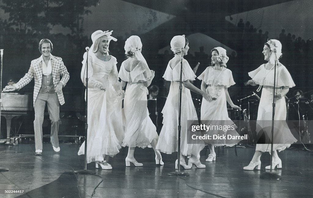 Pat Boone, his wife and four daughters had 15,000 fans singing and clapping last night at the Forum