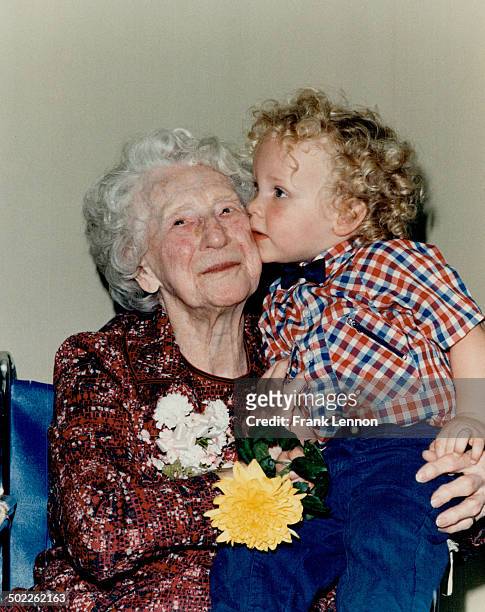 Happy 100th: Kyle Kenney; 2; plants a congratulatory kiss on the cheek of his great-great-aunt Emma Hague-Maundrell at her 100th birthday celebration...