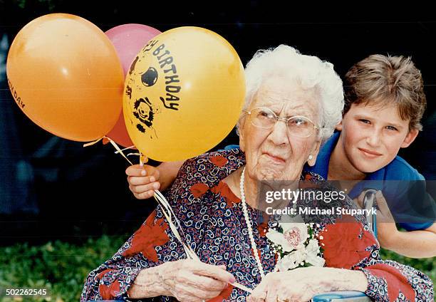 Generation gap: Sara Blakely Moore; who celebrated her 100th birthday yesterday; poses with great-grandson David Grislis; 10; of Rhode Island; one of...