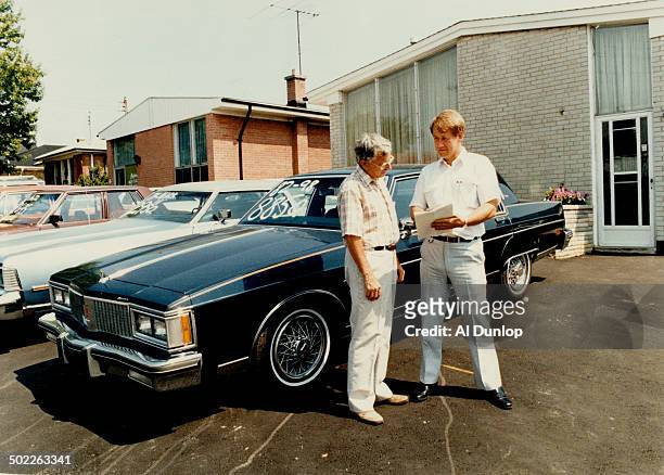 Used-car problems: Scarborough Alderman Kurt Christensen and Kennedy Rd.- Summer Drive-area resident Peter Roberts stand in a used-car lot which...