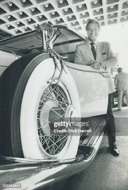 Lex Barker, actor, arrives at the Sutton Place Hotel in 1931 Dusenberg, one of the vintage cabs of the Craven Foundation collection. Barker, who is a...