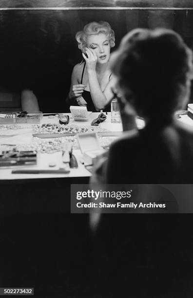 Marilyn Monroe at a makeup table getting ready for an event in 1955 in New York, New York.