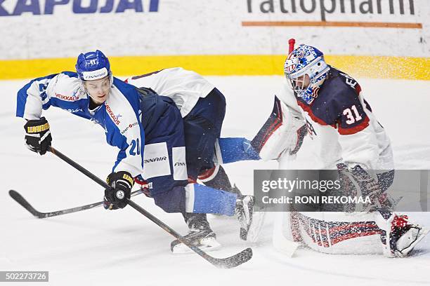 Finland's Sebastian Aho tries to score past US Alex Nedelikovic during ice hockey friendly match Finland vs USA in Lahti, Finland on December 22,...