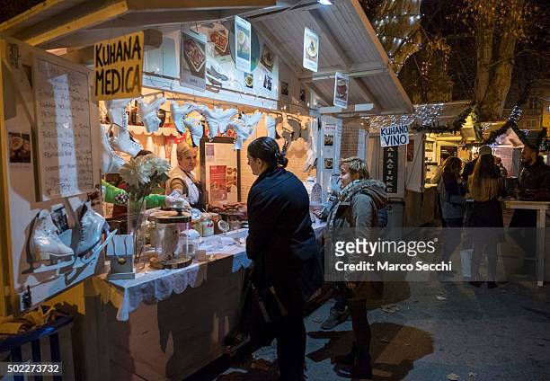 Woman buys mulled wine at one of the stalls of the Advent Market in the city centre on December 22, 2015 in Zagreb, Croatia. Zagreb was voted last...