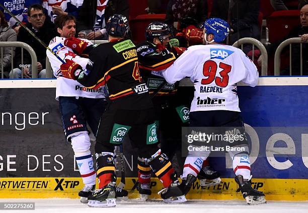 Brent Raedeke of MAnnheim fights with Alexander Preibisch and Timothy Conboy of Duesseldorf during the DEL match between Duesseldorfer EG and Adler...