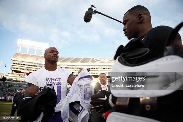 Adrian Peterson of the Minnesota Vikings exchanges his jersey with Aldon Smith of the Oakland Raiders after their game at O.co Coliseum on November...