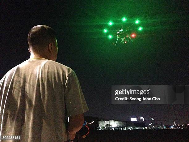 Flying octocopter drone at the background of Kintex at night in Goyang, South Korea.