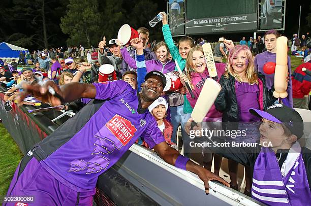 Darren Sammy of the Hurricanes poses after signing autographs for young supporters in the crowd after the Big Bash League match between Hobart...