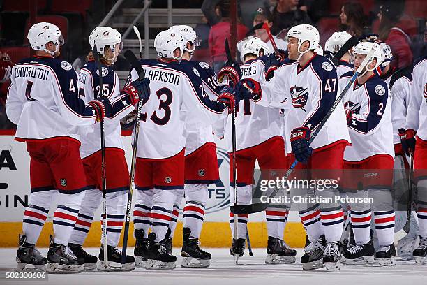 Dalton Prout of the Columbus Blue Jackets high-fives David Clarkson and William Karlsson following the NHL game against the Arizona Coyotes at Gila...