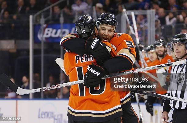 Corey Perry of the Anaheim Ducks scores at 11:16 of the first period against the New York Rangers and is embraced by Clayton Stoner at Madison Square...